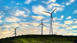 Windmills on a Lush Green Plateau with Cloudy Dusk